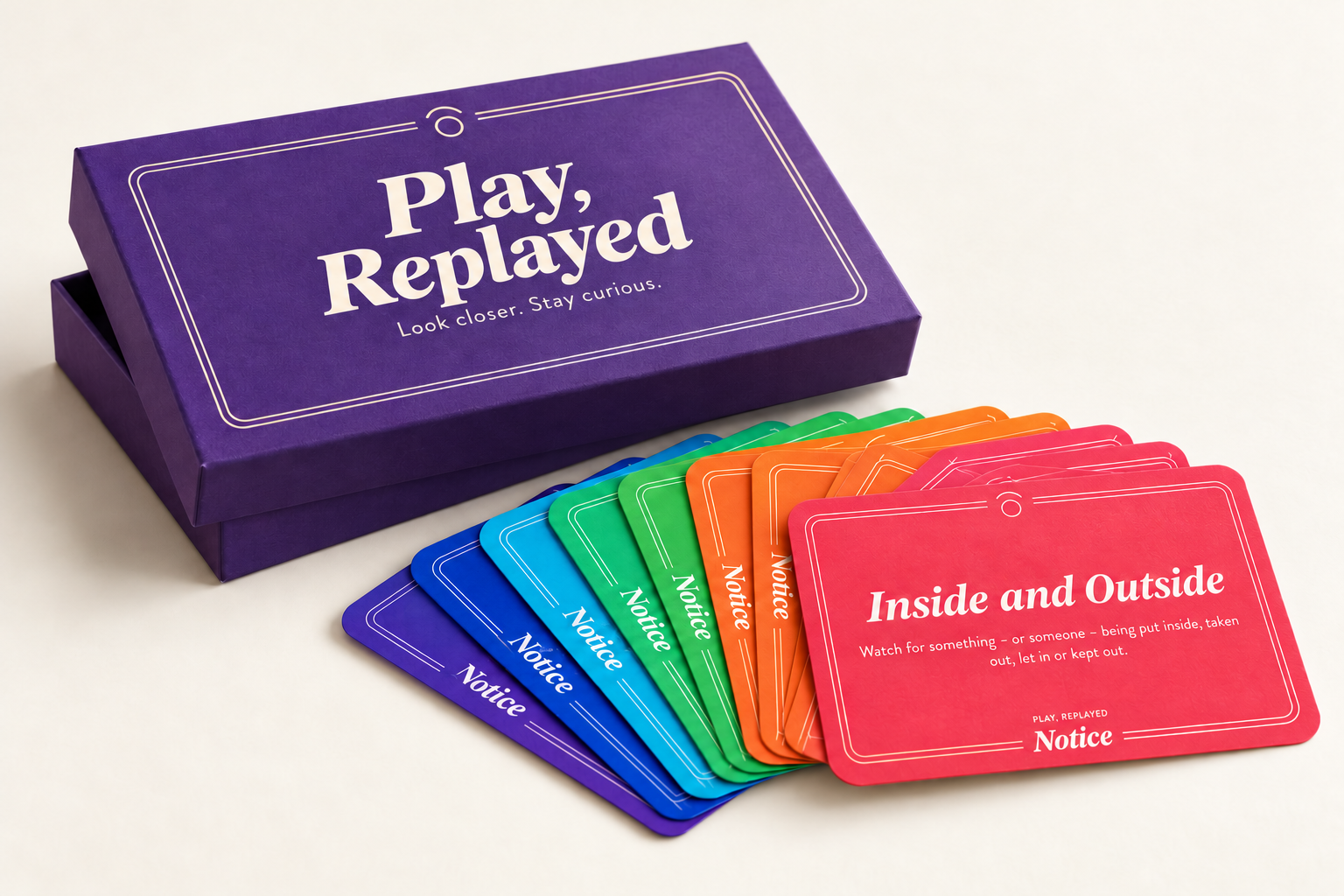 Packaging concept: a violet Play, Replayed box with a fan of colourful Notice cards